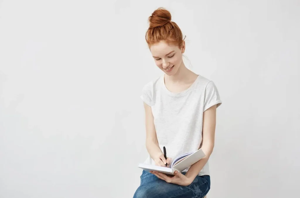 Person writing in notebook