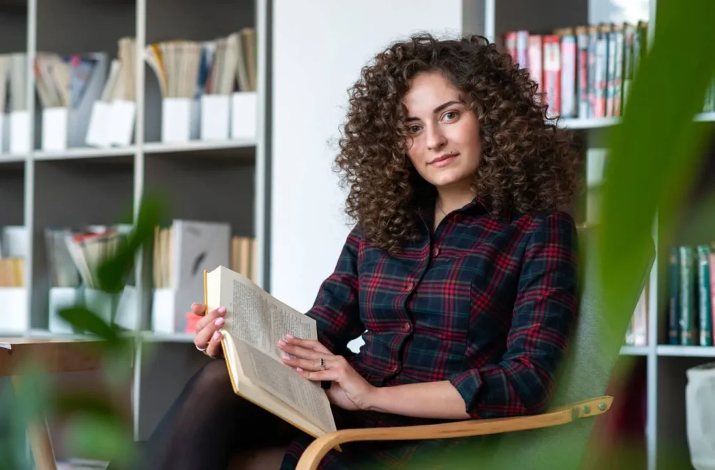 Woman reading a book in library