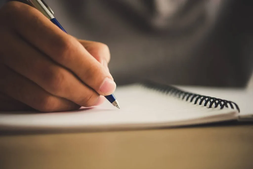 Writing notes in notebook